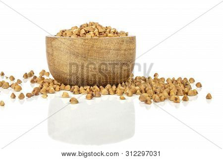 Lot Of Whole Hulled Raw Brown Buckwheat Grain In A Wooden Bowl Isolated On White Background