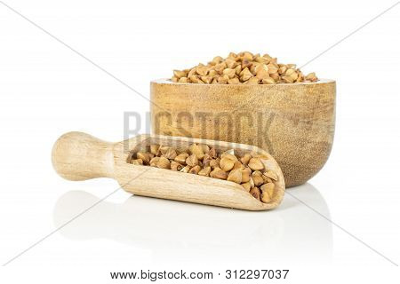 Lot Of Whole Raw Brown Buckwheat Grain In A Wooden Bowl With Wooden Scoop Isolated On White Backgrou