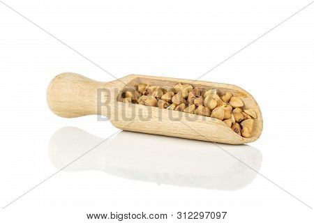 Lot Of Whole Raw Brown Buckwheat Grain With Wooden Scoop Isolated On White Background