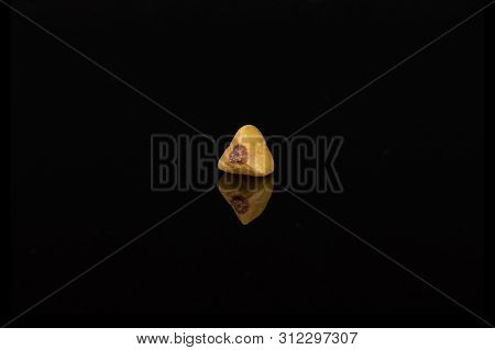 One Whole Raw Brown Buckwheat Grain Isolated On Black Glass