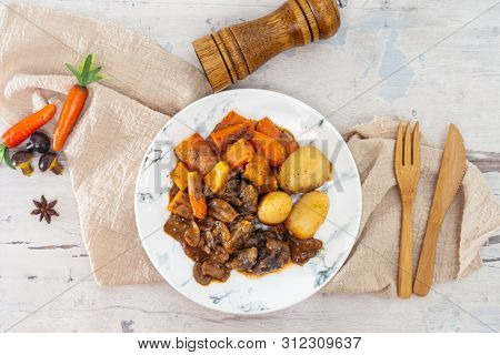 Beef meat stewed with potatoes-Traditional French cuisine Beef Bourguignon potatoes carrots in persillade