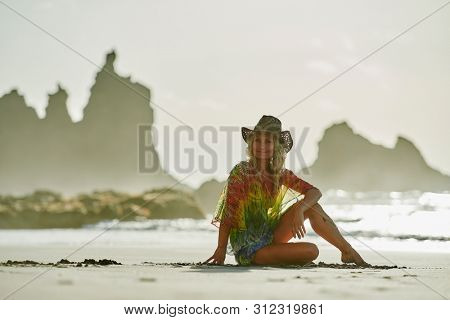 young woman relaxing on the beach in summer day