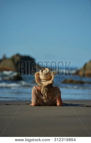 young woman relaxing on the beach in summer day