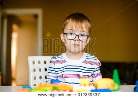 Little Ginger Boy With Glasses With Syndrome Dawn Playing