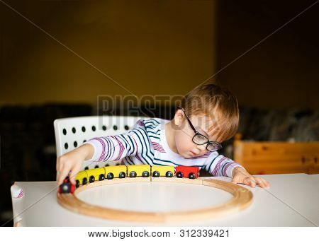 Little Ginger Boy With Glasses With Syndrome Dawn Playing