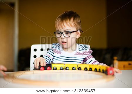 Little Ginger Boy With Glasses With Syndrome Dawn Playing