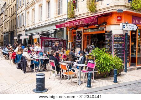 Bordeaux, France - May 5, 2019: Typical Bordeaux City Scene. Residents Of The City And Tourists Rela
