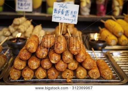 Northern Thai Spicy Sausage (sai Aua) In Multiple Languages On The Tray Ready To Eat
