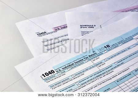 Tax Form 1040, Schedule D, 1040a On A White Background