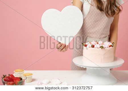 Close Up Cropped Chef Cook Confectioner Or Baker In Apron White T-shirt Cooking Cake Or Cupcake At T