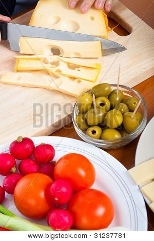 Preparing Olives And Emmenthal Cheese
