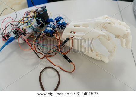 Artificial Robotic Hand At The Presentation Of Robotics. An Implant For A Human Hand. Creation Of Ar