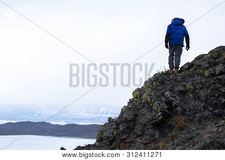 Man Standing On Top Of Rock Mountain And Looking At Landscape View Of Lake And Mountain, Lake Bikal 