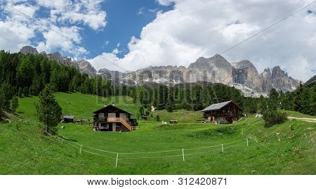 Panorama Of Catinaccio (rosengarten) Massif And Vajolet Towers. Alpine Wooden Houses And Grassland O