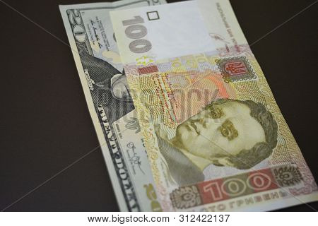 Paper Bills In The Size Of Usd 20 $ Twenty American Dollars And Uah 100 One Hundred Ukrainian Hryvni