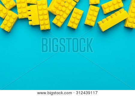 Top View Of Yellow Plastic Blocks. Flat Lay Image Of Yellow Blocks From Child Constructor. Bright Pl