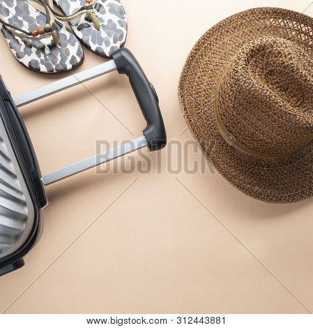 Flat Lay Grey Suitcase With Brown Hat And Sandles On Pastel Background. Travel Concept - Image