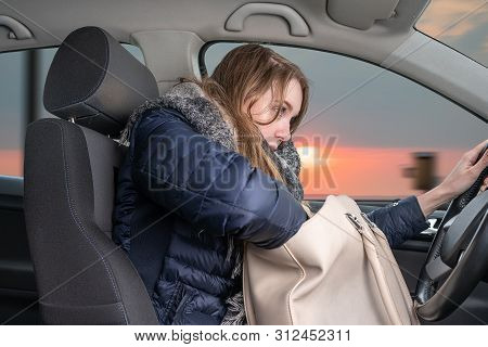 A Young Woman Is Distracted While Driving Car
