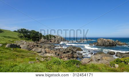 Tanesashi Kaigan Coast. The Coastline Includes Both Sandy And Rocky Beaches, And Grassy Meadows Scen