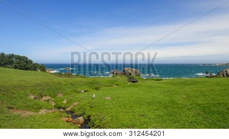 Tanesashi Kaigan Coast. The Coastline Includes Both Sandy And Rocky Beaches, And Grassy Meadows Scen