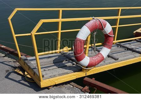 Lifebuoy Hangs On The Railing Of The Transitional Bridge