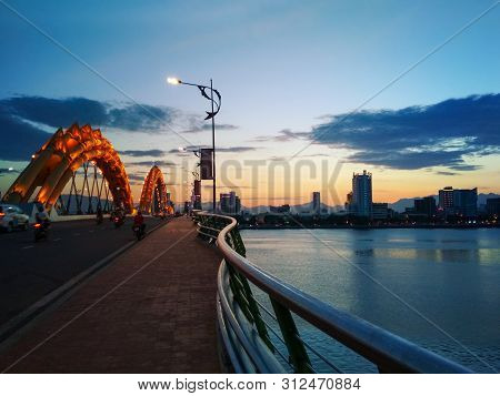 Sunset Over Beautiful Red Dragon Bridge Bridge With Cityscape In The Background