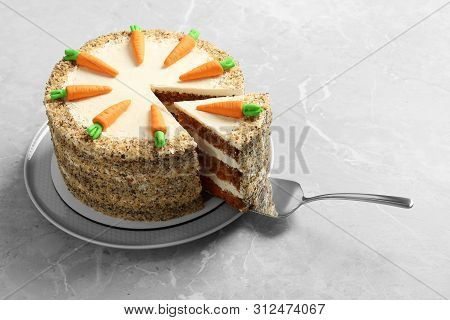 Sweet Carrot Cake With Delicious Cream And Server On Grey Marble Table. Space For Text