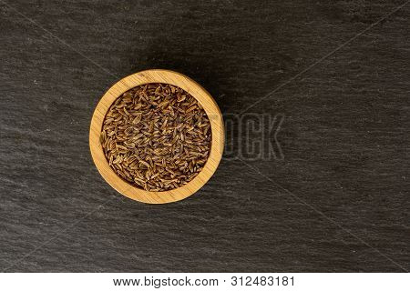 Lot Of Whole Dry Caraway Fruits Copyspace In A Wooden Bowl Flatlay On Grey Stone
