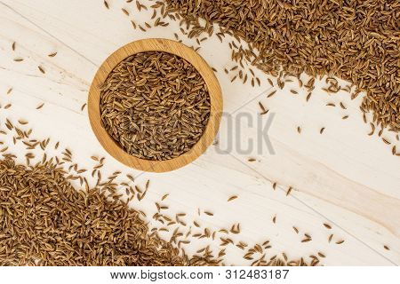 Lot Of Whole Dry Caraway Fruits Crescent In A Wooden Bowl Flatlay On White Wood