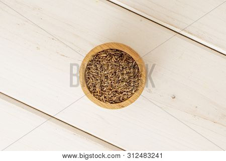 Lot Of Whole Dry Caraway Fruits In A Wooden Bowl Flatlay On White Wood