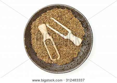 Lot Of Whole Dry Caraway Fruits In A Grey Ceramic Bowl With Wooden Scoop Flatlay Isolated On White B