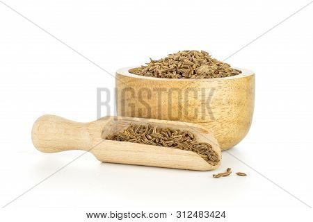 Lot Of Whole Dry Caraway Fruits In A Wooden Bowl With Wooden Scoop Isolated On White Background