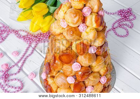 Croquembouche With Pink Roses And Caramel Threads. Traditional Cake Of French Cuisine.