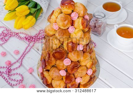 Croquembouche With Pink Roses And Caramel Threads. Traditional Cake Of French Cuisine.