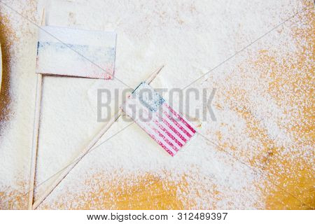 Russian And Us Flags On The Floured Table. Concept Of Relationships In Economics And Politics