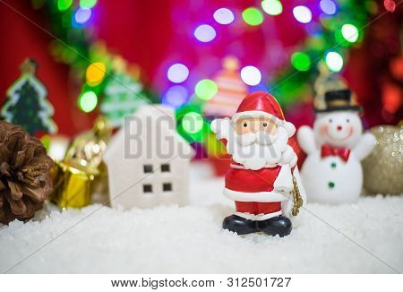 Santa Claus Doll With Bokeh Background And Happy New Year Concept