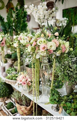 Many Flowers On Table In Florist Shop, Copy Space. Small Business. Floral Design Studio, Luxury Wedd