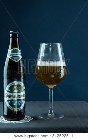 Khabarovsk, Russia - Jul 21, 2018: Beer Bottle Weihenstephan And A Glass Of Beer On Table On Blue Ba