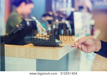 Hand Put Credit Card In Slot Of Credit Card Reader With Blurry Cashier At Counter Service, Credit Ca
