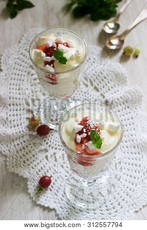Eton Mess, Traditional English Dessert With Gooseberry, Whipped Cream And Meringue On A Light Backgr