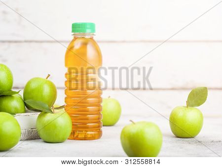 Bottle Of Fresh Organic Apple Juice With Granny Smith And British Bramley Apples In Box On Wooden Ba