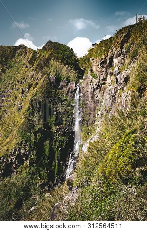 View Towards Waterfall In Nordeste Near Lighthouse Ponta Do Arnel In Sao Miguel Island, Azores