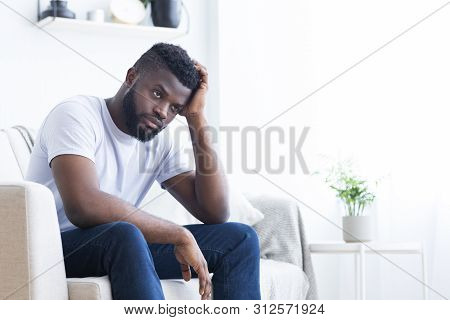 Loneliness. Stressed African American Guy Thinking About Problems At Home Alone, Free Space