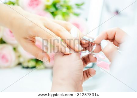 Woman having a manicure in beauty parlor