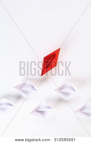 Red Paper Boat Among Other White. Leadership, White Crow, Individuality. Piranhas And A Shark. Not L