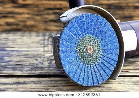 Angle Grinder With Grinding Disc Brushes And Abrasive Wire Brushes Lies On The Background Of A Old W