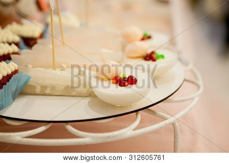 Panakota On The Wedding Table. Gentle White Wedding Cake And Different Sweets On Table.