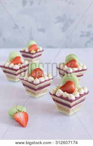 Vanilla Sponge Cake With Strawberry Sauce In A Cup Garnished With Fresh Klyubnika And Macaroons