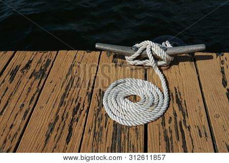 Dock On A Lake With A Dockline On A Cleat.