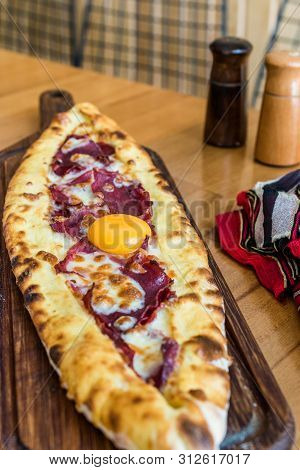 Traditional Turkish Pide At Kebab Restaurant On Wooden Table.